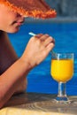 Beautiful woman ready to enjoy juice by the pool Royalty Free Stock Photo