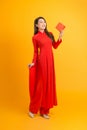 Beautiful woman in red ao dai dress holding gift box Royalty Free Stock Photo