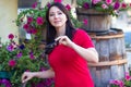 Beautiful woman in a red blouse in a flower bed