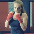 Beautiful Woman with the Red Boxing Gloves. Attractive Female Boxer Training. Royalty Free Stock Photo