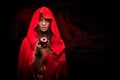 Beautiful woman with red cloak holding apple Royalty Free Stock Photo