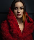 Beautiful woman red cloak with red flowers roses in studio Royalty Free Stock Photo