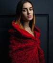 Beautiful woman red cloak with red flowers roses in studio Royalty Free Stock Photo