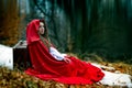 Beautiful woman with red cloak in the woods Royalty Free Stock Photo