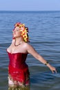 Beautiful woman in a red corset and floral chaplet