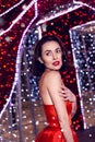 Beautiful woman in red dress in christmas decor background beauty portrait photoshoot Royalty Free Stock Photo