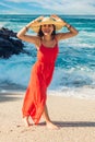 Beautiful woman enjoys the view of waves on sunny beach. Happy woman smiling. Summer vacation concept Royalty Free Stock Photo