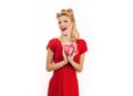 Beautiful woman in red dress holding heart over white background isolated. St. Valentine`s day. Royalty Free Stock Photo