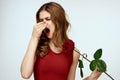 Beautiful woman in a red dress holds a rose in her hand a gift flowers decoration attractive look Royalty Free Stock Photo