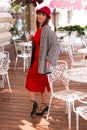 A beautiful woman in a red dress is resting in a cafe. Royalty Free Stock Photo