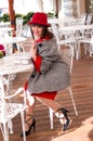 A beautiful woman in a red dress is resting in a cafe. Royalty Free Stock Photo