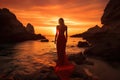 Beautiful woman in red dress standing on the beach and looking at the sunset, Epic red sunset in Cala Llentrisca with model ,