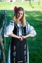 Beautiful woman with red flower in her hair posing in Romanian t Royalty Free Stock Photo