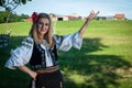 Beautiful woman with red flower in her hair posing in Romanian t Royalty Free Stock Photo