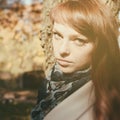 Beautiful freckle woman with red hair in autumn park