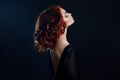 Beautiful woman with red hair on a black background. Portrait of a successful woman, pure skin, natural makeup, skin care face Royalty Free Stock Photo