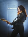 Beautiful woman with red hair playing electric guitar Royalty Free Stock Photo