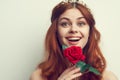 beautiful woman with red hair red rose flower close up Royalty Free Stock Photo