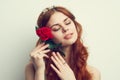 beautiful woman with red hair red rose flower close up Royalty Free Stock Photo