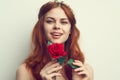 beautiful woman with red hair red rose flower close up Royalty Free Stock Photo