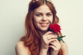 beautiful woman with red hair red rose flower close up Royalty Free Stock Photo