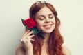 beautiful woman with red hair red rose flower close up Royalty Free Stock Photo