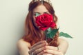 beautiful woman with red hair red rose flower close up Royalty Free Stock Photo