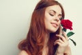 beautiful woman with red hair red rose flower close up Royalty Free Stock Photo