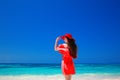 Beautiful woman with red hat enjoying on tropical beach, fashion