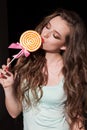 Beautiful woman with red lips eats candy big sweet lollipop Royalty Free Stock Photo