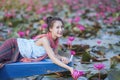 Beautiful woman with the red lotus sea Royalty Free Stock Photo