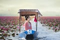 Beautiful woman with the red lotus sea Royalty Free Stock Photo