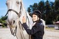 Beautiful woman with red nail art fond of equestrianism