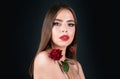 Beautiful woman with red rose flower isolated on black background. Pink lips and rose. Beauty girl. Sensual sexy mouth Royalty Free Stock Photo