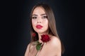 Beautiful woman with red rose flower isolated on black background. Pink lips and rose. Beauty girl. Sensual sexy mouth Royalty Free Stock Photo