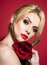 Beautiful woman with red rose flower. Pink lips and rose. Beauty girl. Sensual sexy mouth. Nofilter unaltered skin. Royalty Free Stock Photo