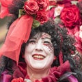 Beautiful woman in red roses, carnival Zurich