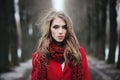 Beautiful woman in red scarf in cold winter park. Royalty Free Stock Photo