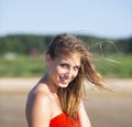 Beautiful woman in red shawl posing on sea beach Royalty Free Stock Photo