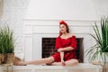 Beautiful woman in red. Stylish model with red lipstick on the lips, bright nail polish. Girl in a suit with a retro headdress Royalty Free Stock Photo