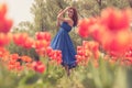 Beautiful woman in red tulip flowers field Royalty Free Stock Photo