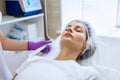 Beautiful woman on rejuvenation procedure in beauty clinic. Royalty Free Stock Photo