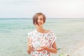 Beautiful woman relax during exotic vacation on the beach enjoying sweet coffee Royalty Free Stock Photo