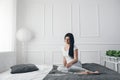 Beautiful woman relaxing on the bed and using her tablet Royalty Free Stock Photo