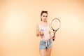 Beautiful woman relaxing and drinking lemonade after game. Royalty Free Stock Photo