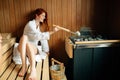 Beautiful woman relaxing in finnish sauna Royalty Free Stock Photo