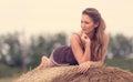 Beautiful woman relaxing on hay bale Royalty Free Stock Photo