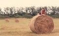 Beautiful woman relaxing on hay bale Royalty Free Stock Photo