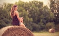 Beautiful woman relaxing on hay bale Royalty Free Stock Photo