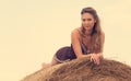 Beautiful woman relaxing on hay bale Royalty Free Stock Photo